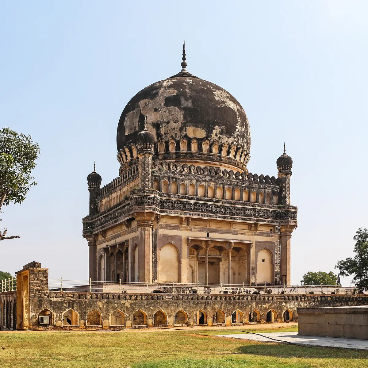 Tomb of Muhammad Quli Qutb Shah framed by trees in Hyderabad