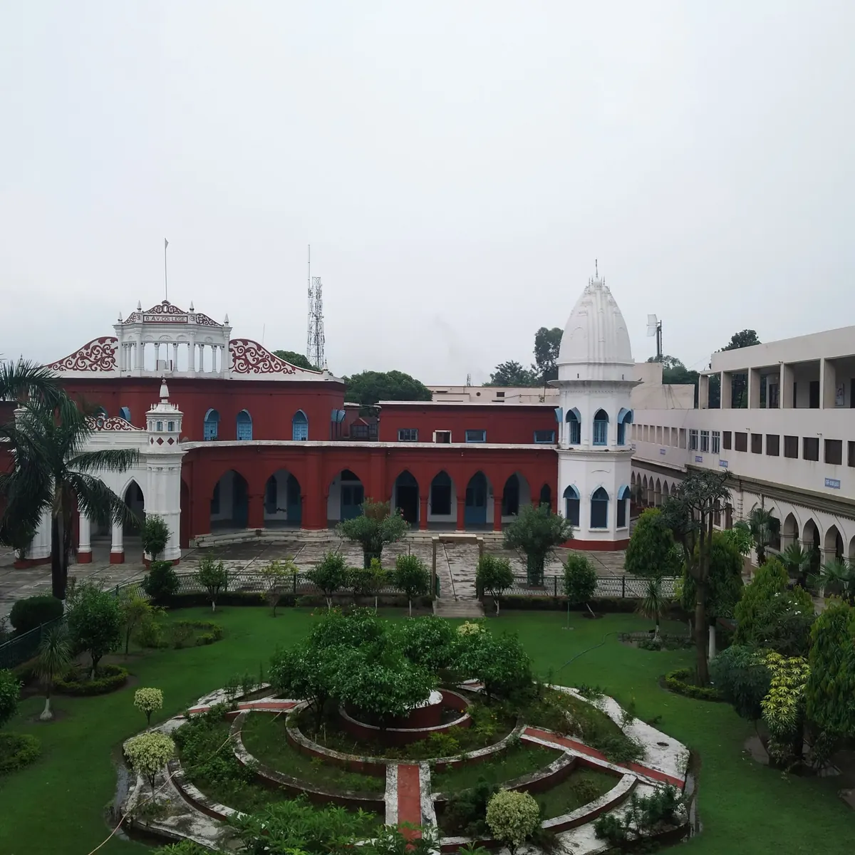 Red and white DAV College buildings and garden in Jalandhar