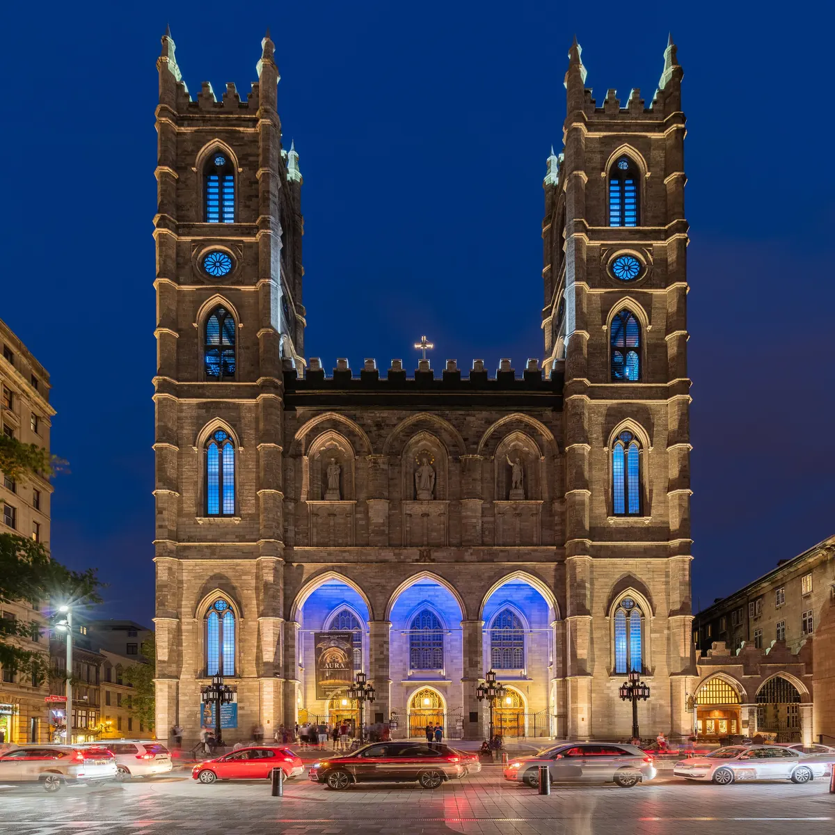Twin towers of Notre-Dame Basilica lit at night in Montreal