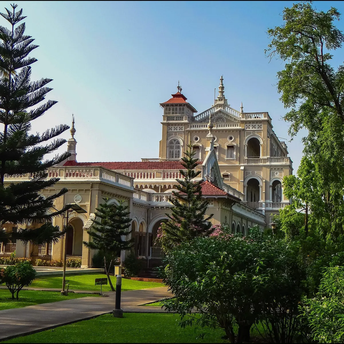 Aga Khan Palace framed by trees and gardens in Pune